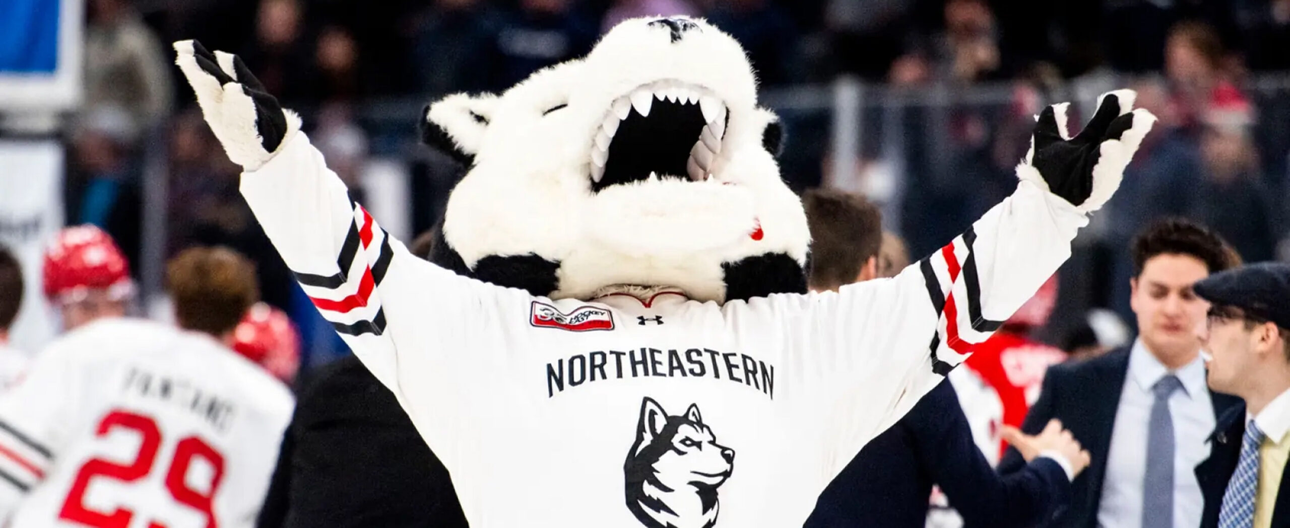 Paw mascot cheering at a northeastern hockey game