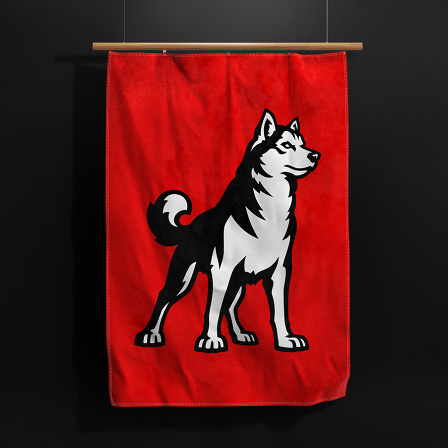 A red banner featuring a bold, stylized black and white husky dog standing alertly, displayed hanging against a dark background.