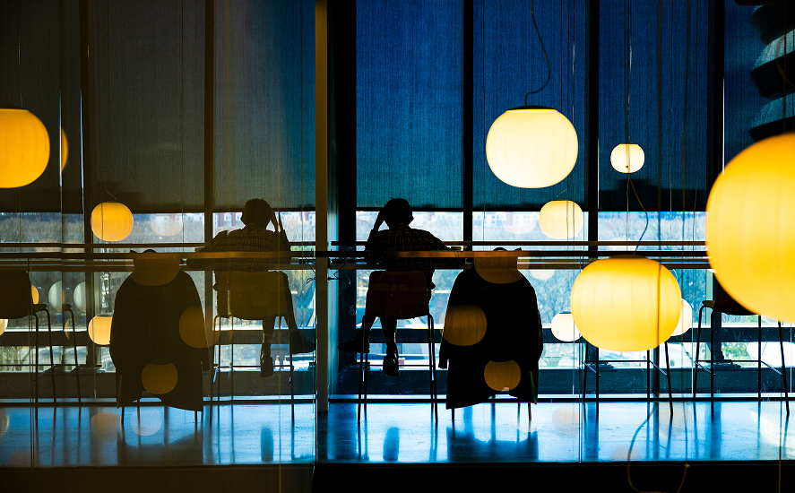 Students studying at a table in dim lighting